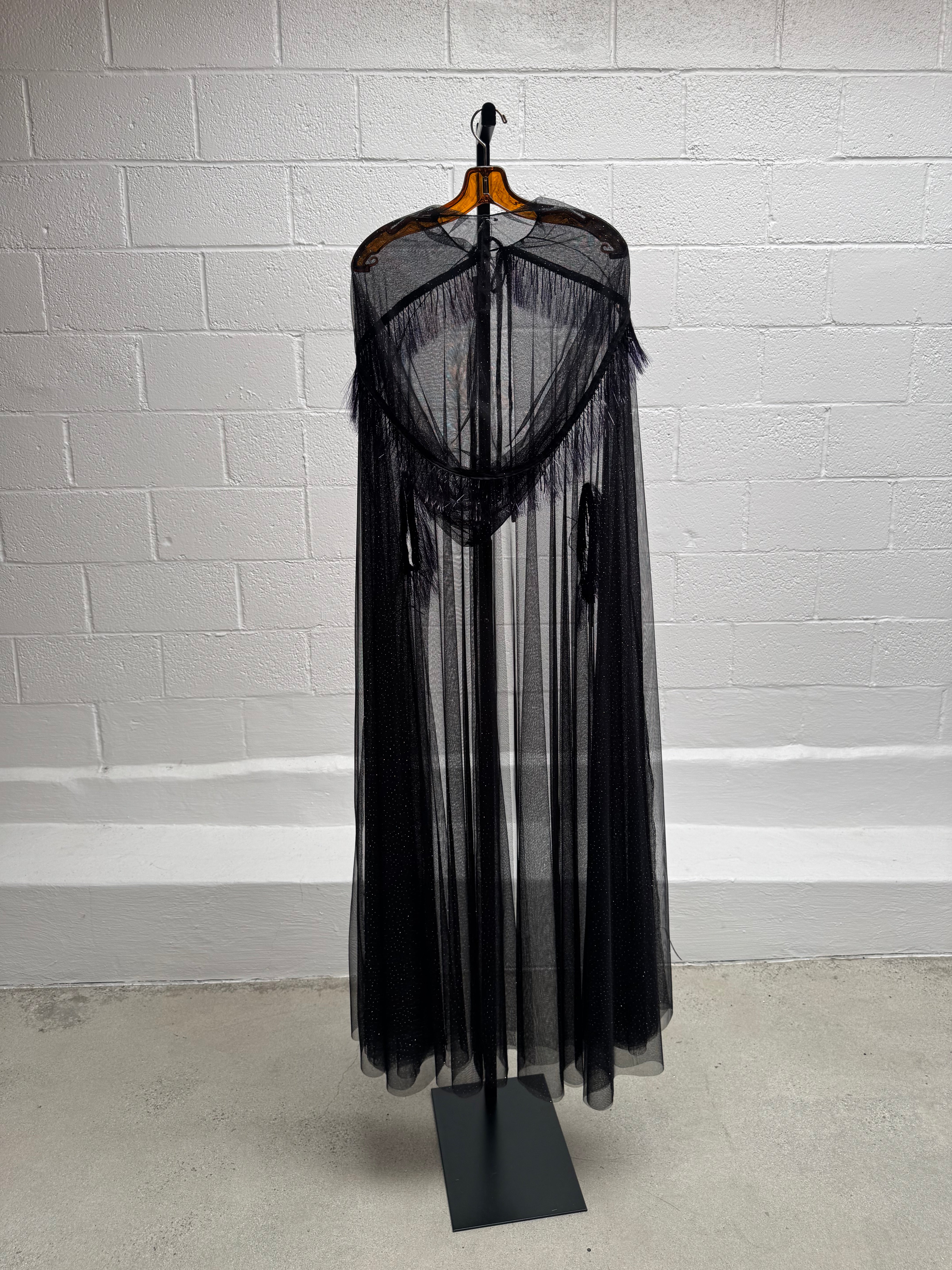 Cape with metallic fringe details
