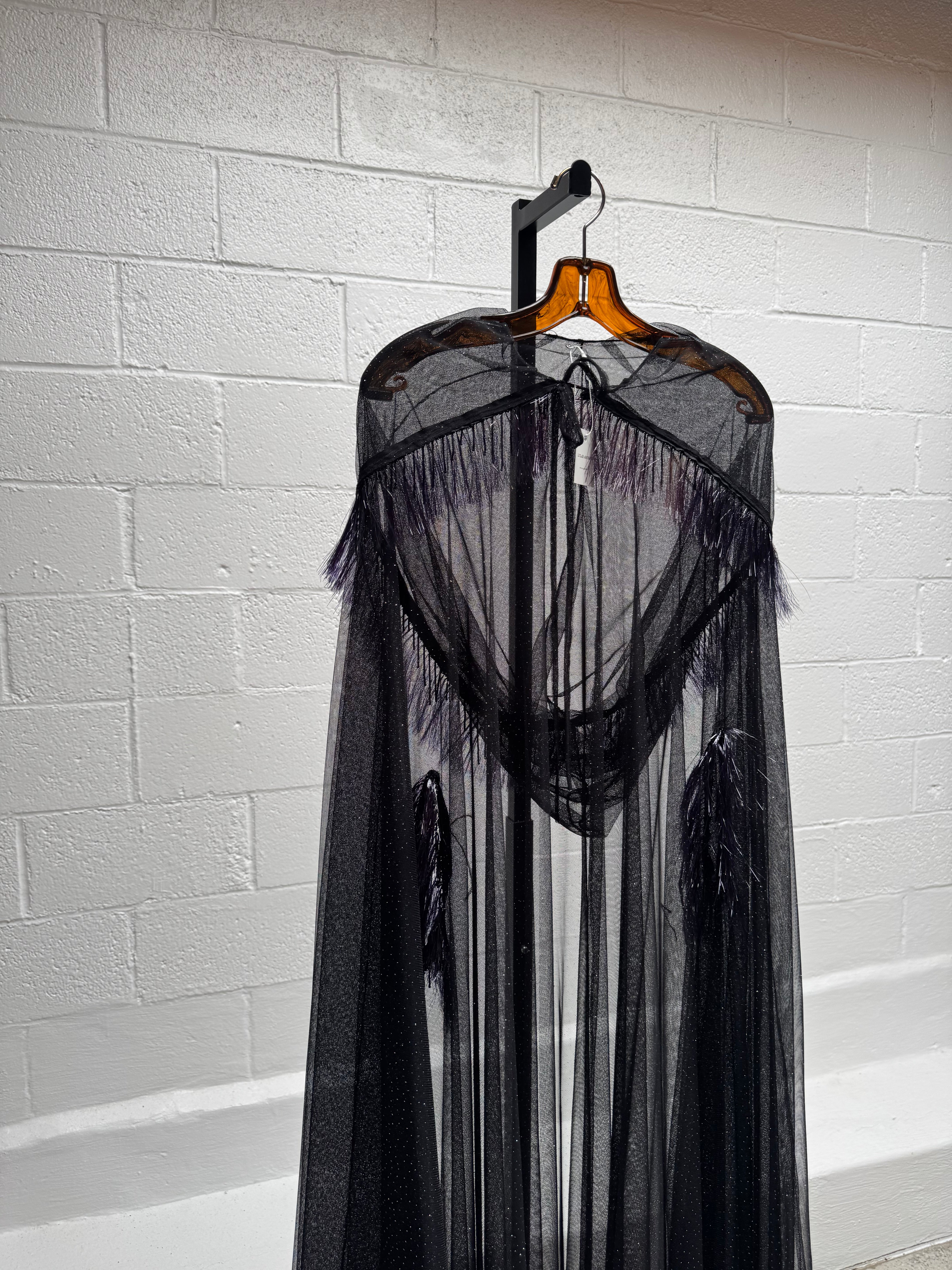 Cape with metallic fringe details