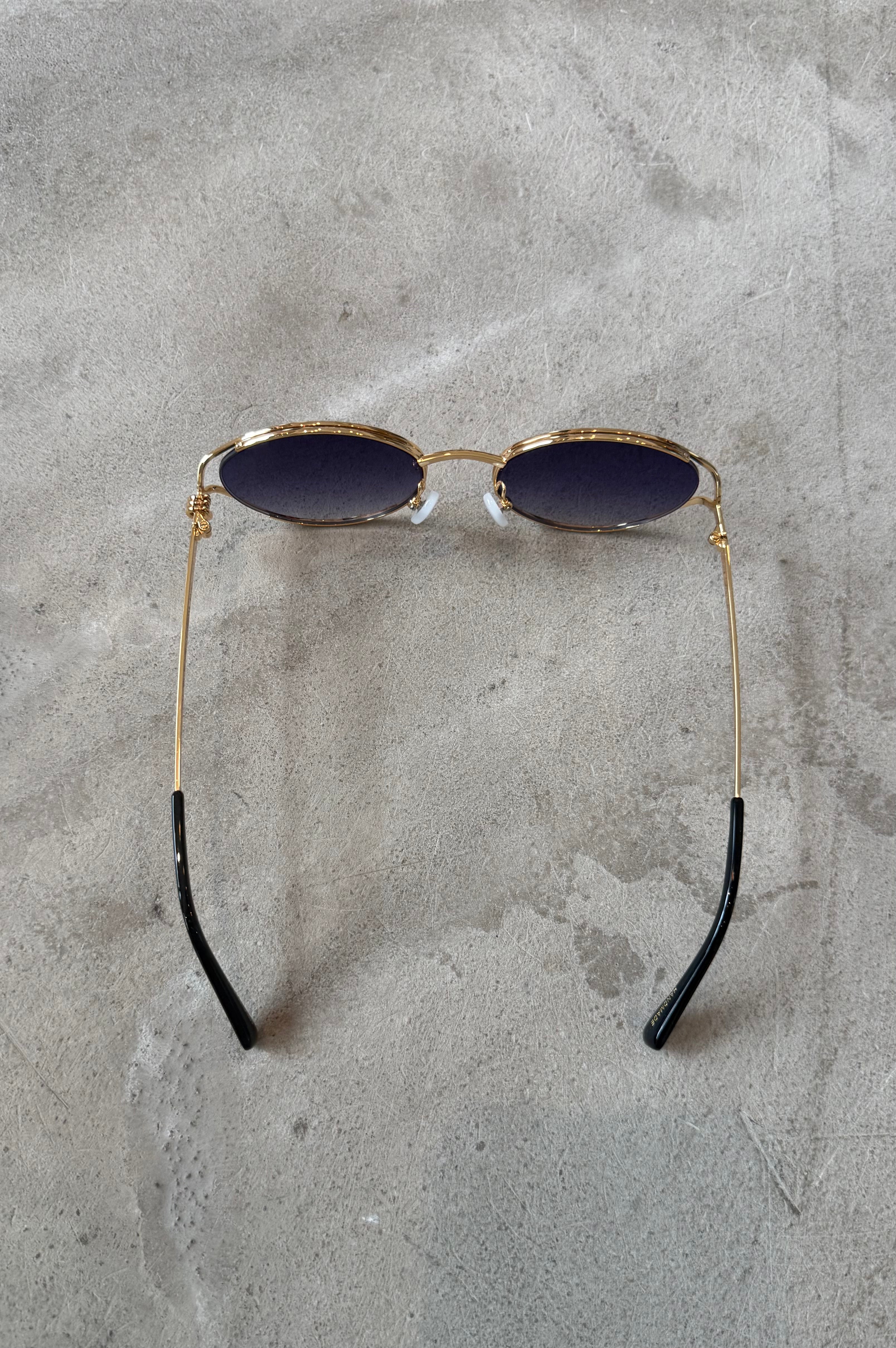 Sunglasses with gold frame and dark lenses