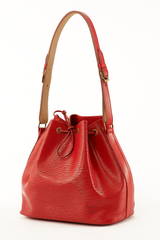 Louis Vuitton Noé bucket bag in red Epi leather with adjustable natural leather shoulder strap and gold-tone hardware, luxury designer drawstring shoulder bag.